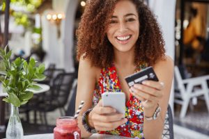 Smiling woman saving money on her cell phone bill