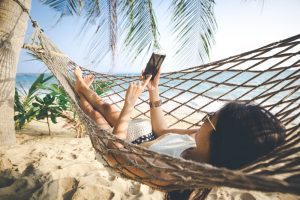 woman using her phone in a hammock