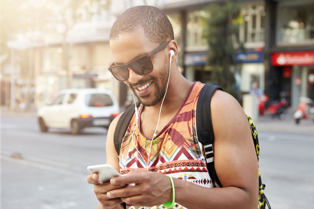 man unlocking his phone on the go